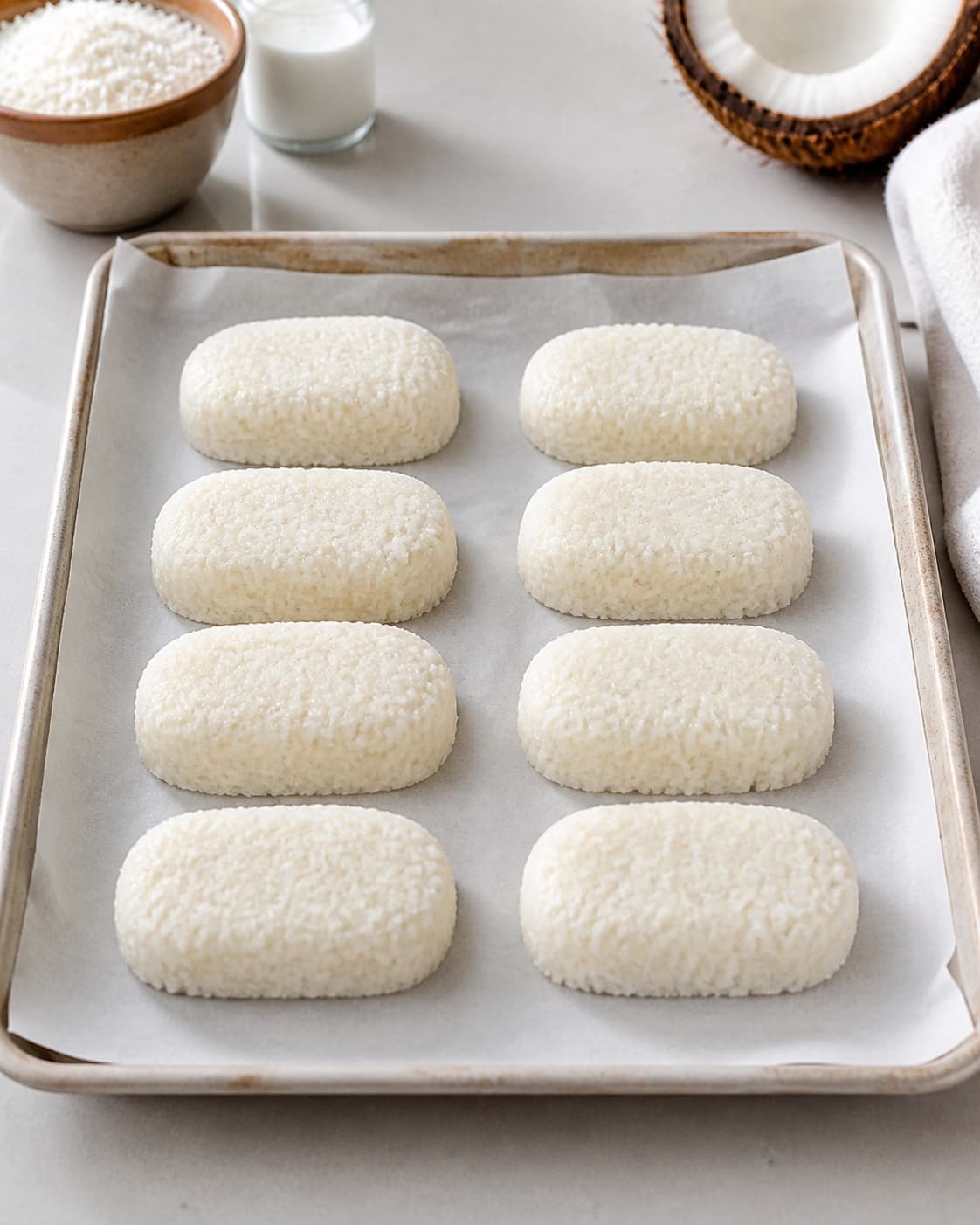 Eight coconut bars shaped evenly on baking paper and chilled firm under tilberedningen af bounty