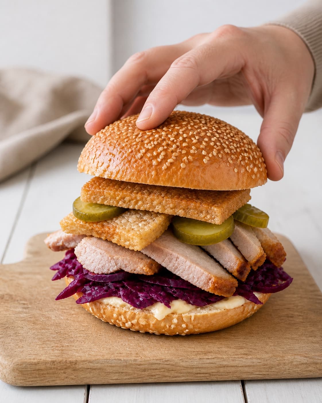 Pork roast sandwiches assembled with red cabbage pickles mustard mayonnaise and exposed crisp crackling under tilberedningen af flæskestegssandwich med rødkål og sennepsmayonnaise
