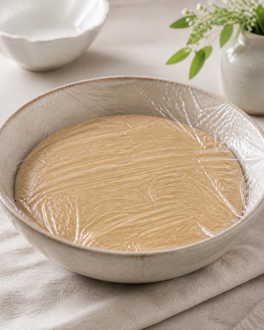 Smooth marzipan kransekage mixture resting chilled under contact film under tilberedningen af kransekage med sprød kant og blød kerne