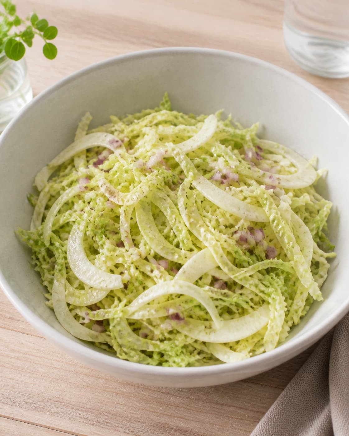 One large bowl of lightly dressed glossy pointed cabbage, fennel and red onion, no chorizo pomegranate cress or finished platter under tilberedningen af spidskålssalat med chorizo og granatæble