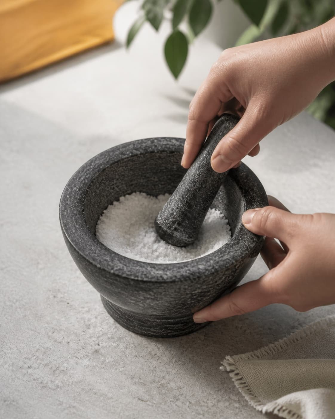 One mortar holding finely crushed white sugar crystals, no cocoa chocolate spices jars or milk under tilberedningen af kakaopulver til varm kakaomælk