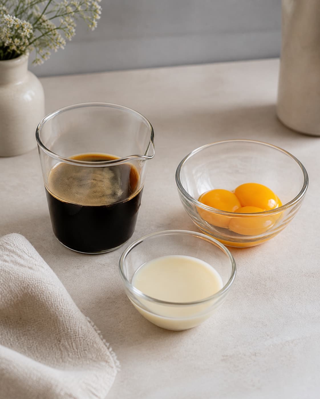 One single photorealistic instructional frame of measured drink components arranged separately for Hanoi Egg Coffee, featuring stærk vietnamesisk kaffe, pasteuriserede æggeblommer, kondenseret mælk, with only the named equipment and no unrelated food, text, logos or packaging under tilberedningen af hanoi egg coffee