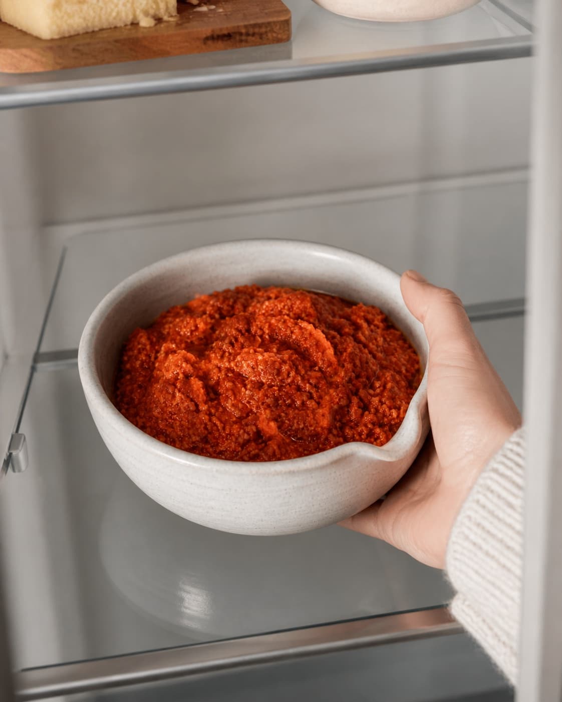 One single photorealistic instructional frame of the completed dip in one clean bowl after chilling for Tomatpesto, featuring soltørrede tomater, parmesan, mandler, with only the named equipment and no unrelated food, text, logos or packaging under tilberedningen af tomatpesto