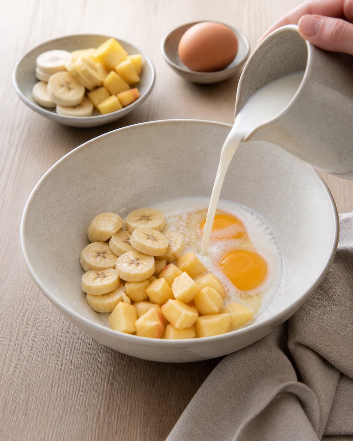 One single photorealistic instructional frame of measured grains seeds and liquid before cooking for Morgenmadspandekager uden havregryn eller mel, featuring banan, æg, æble, with only the named equipment and no unrelated food, text, logos or packaging under tilberedningen af morgenmadspandekager uden havregryn eller mel