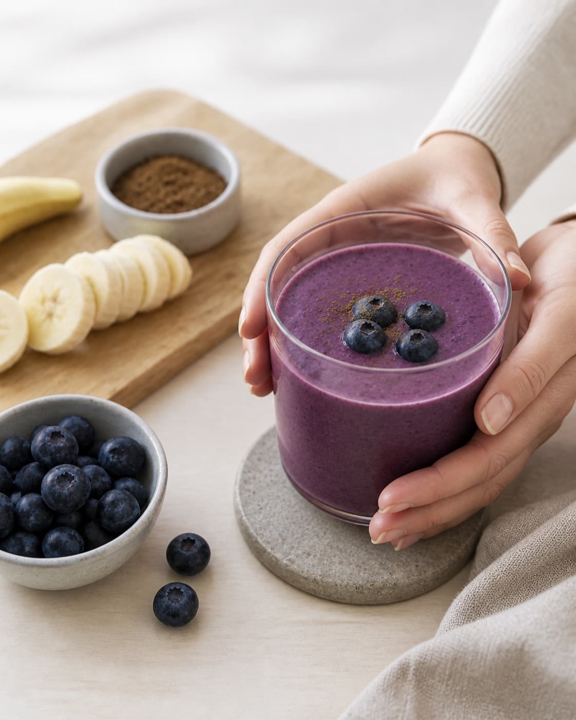 One single photorealistic instructional frame of the finished smoothie poured into clean chilled glasses or bowls for Blåbær og lakridssmoothie, featuring blåbær, banan, lakridspulver, with only the named equipment and no unrelated food, text, logos or packaging under tilberedningen af blåbær og lakridssmoothie