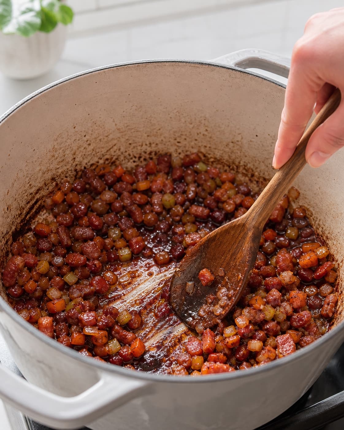 Mør blank soffritto med sprød pancetta og murstensrød tomatpuré er glaseret af rødvin reduceret til en sirupsagtig bund uden væskesø