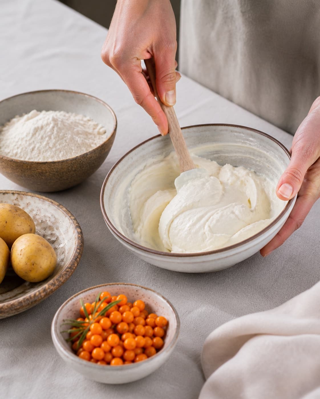 Measured ingredients for kage med kartofler og mascarponecreme med havtorn arranged separately with kartofler, mascarpone, havtorn, hvedemel under tilberedningen af kage med kartofler og mascarponecreme med havtorn