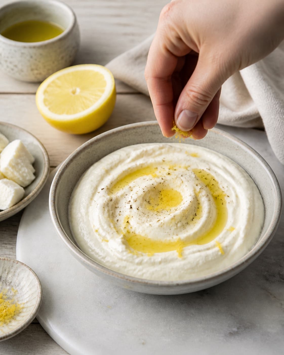 Fresh finished fetacreme / fetadip receiving its final garnish under tilberedningen af fetacreme / fetadip