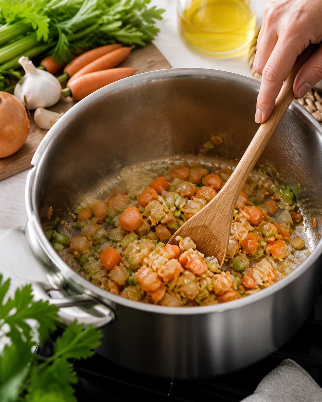 Aromatic base for minestronesuppe gently cooking in a pot under tilberedningen af minestronesuppe