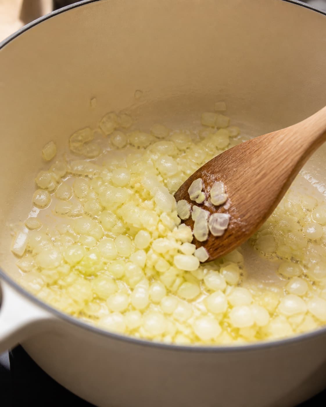 Aromatic base for kikærtegryde med græskar gently cooking in a pot under tilberedningen af kikærtegryde med græskar
