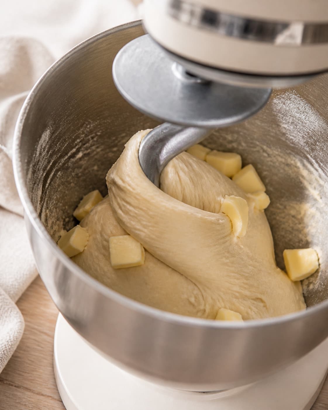 Soft yeast dough with milk egg flour sugar salt and butter coming together under tilberedningen af mandelboller med chokolade