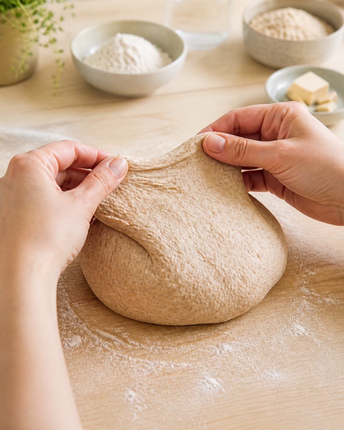 Graham dough being kneaded until moderately elastic with visible bran specks under tilberedningen af grahamsboller – hurtige og nemme boller med grahamsmel