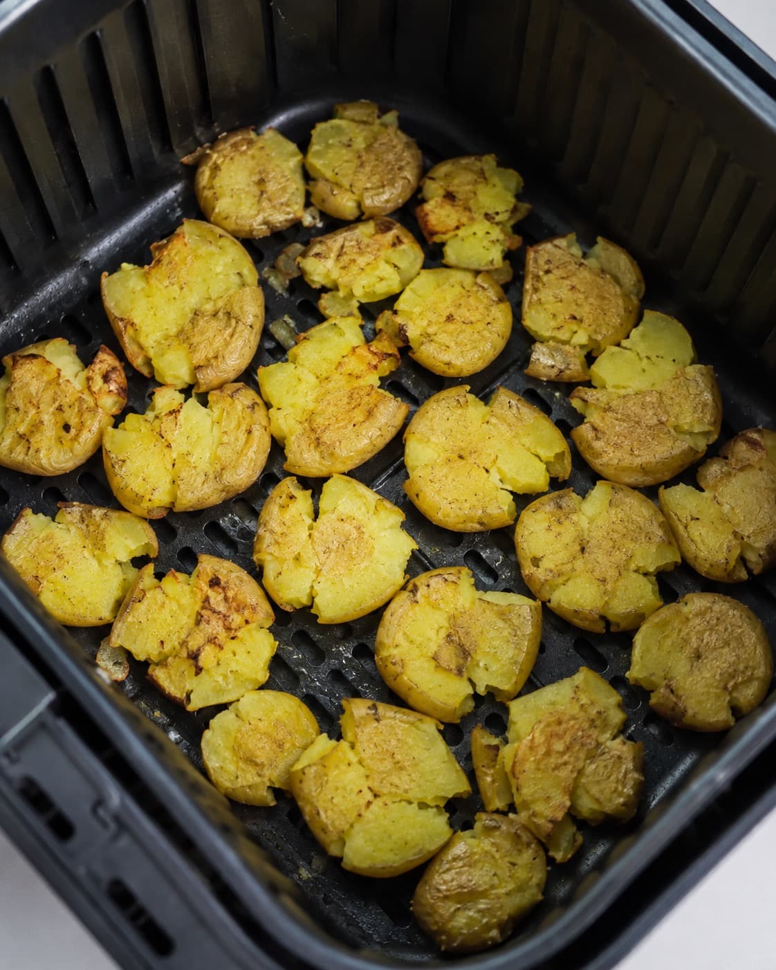 Forkogte knuste kartofler ristes i ét luftigt lag i airfryer-kurven