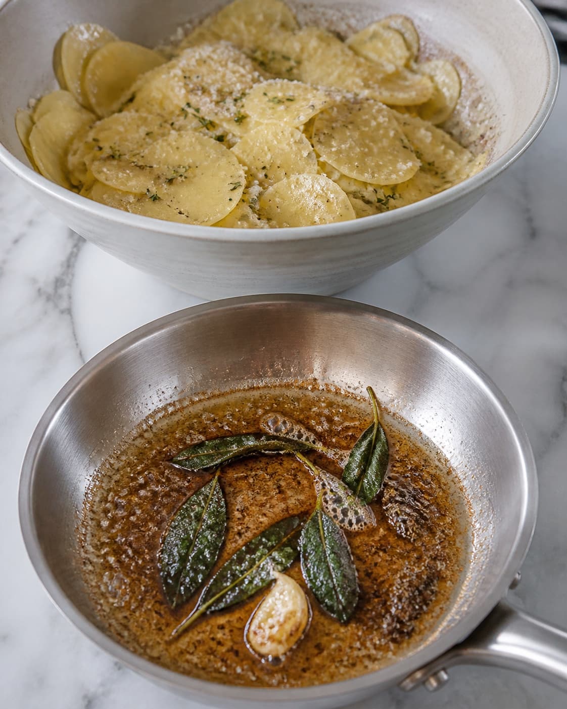 Brunet salviesmør og parmesan fordeles på de tørre kartoffelskiver