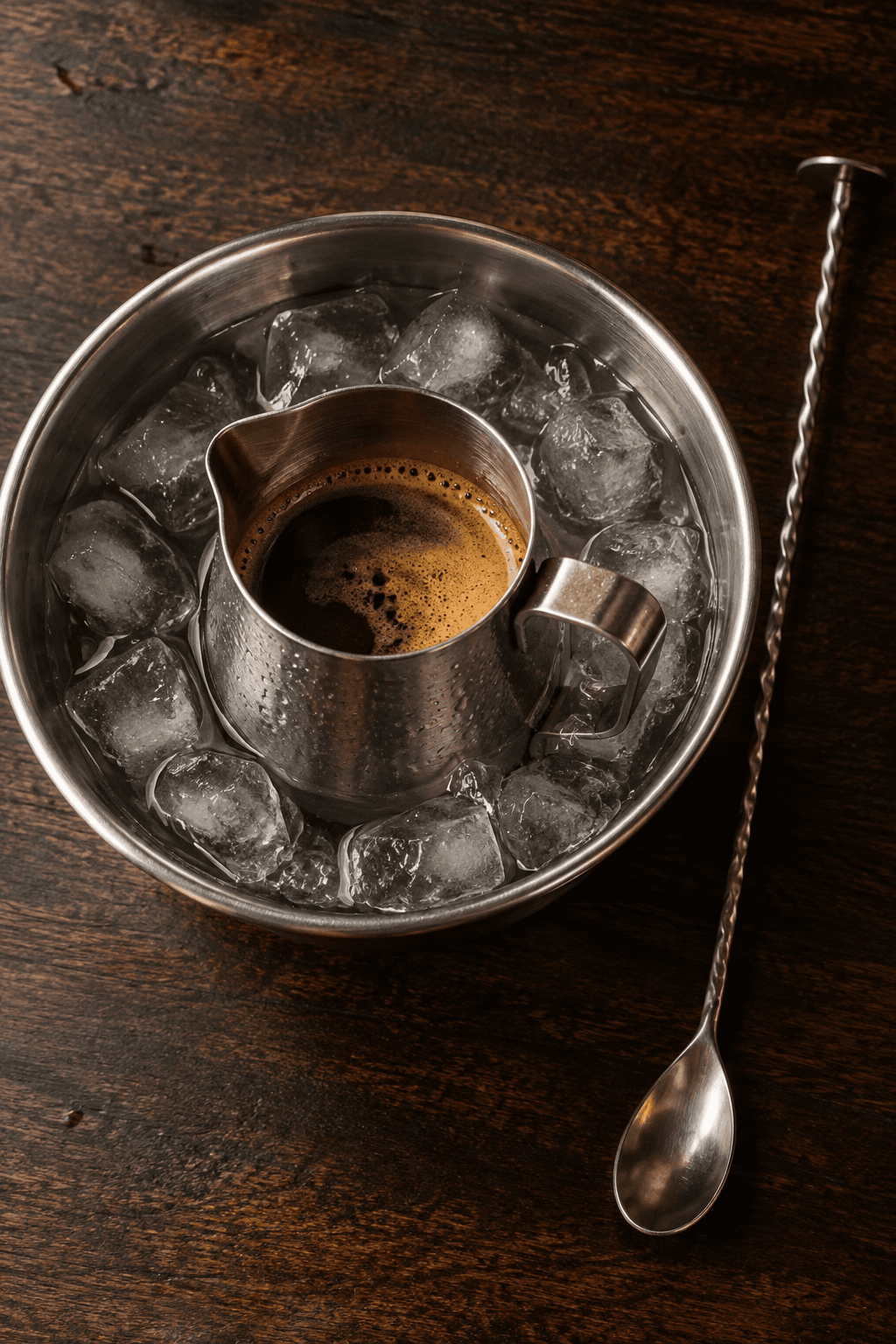 Frisk espresso køles i én metalbeholder placeret i ét isbad